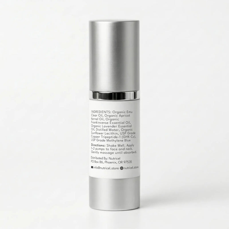 A cylindrical cosmetic pump bottle with a metallic silver cap and a white label showing product ingredients and directions, photographed on a clean white background.