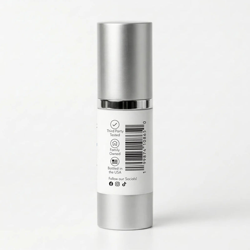 Silver skincare bottle with a white label on a light gray background