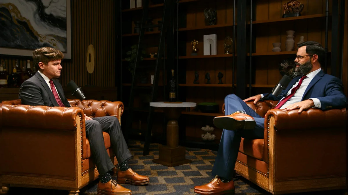 Two hosts in conversation on the NXR Studios set